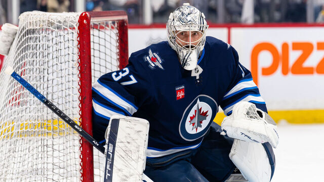 WINNIPEG, CANADA - APRIL 21: Connor Hellebuyck #37 of the Winnipeg Jets warms up before Game Two of the First Round of the 2025 Stanley Cup Playoffs against the St. Louis Blues at Canada Life Centre on April 21, 2025 in Winnipeg, Canada.