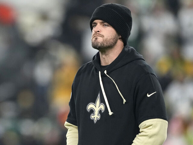 GREEN BAY, WISCONSIN - DECEMBER 23: Derek Carr #4 of the New Orleans Saints looks on before the game against the Green Bay Packers at Lambeau Field on December 23, 2024 in Green Bay, Wisconsin.