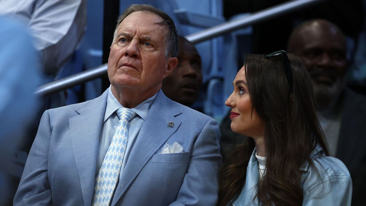 CHAPEL HILL, NORTH CAROLINA - MARCH 08: North Carolina Tar Heels football head coach Bill Belichick and his girlfriend Jordon Hudson look on during the first half of the game between the North Carolina Tar Heels and the Duke Blue Devils at Dean E. Smith Center on March 08, 2025 in Chapel Hill, North Carolina.