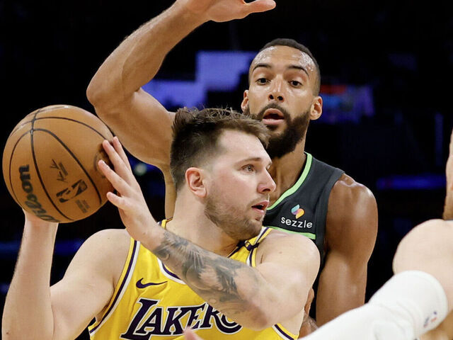 LOS ANGELES, CALIFORNIA - APRIL 30: Luka Doncic #77 of the Los Angeles Lakers looks to pass the ball against Rudy Gobert #27, Donte DiVincenzo #0, and Nickeil Alexander-Walker #9 of the Minnesota Timberwolves during the second quarter in Game Five of the Western Conference First Round NBA Playoffs at Crypto.com Arena on April 30, 2025 in Los Angeles, California.