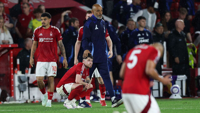 Nottingham Forest's Portuguese manager Nuno Espirito Santo (rear) comforts Nottingham Forest's Welsh defender #07 Neco Williams at the end of the English Premier League football match between Nottingham Forest and Brentford at The City Ground in Nottingham, central England, on May 1, 2025. Brentford wins 2 - 0 against Nottingham Forest.