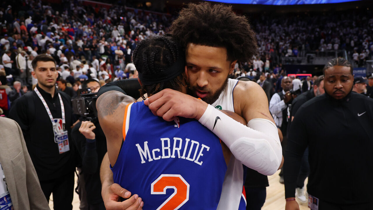 DETROIT, MICHIGAN - MAY 01: Cade Cunningham #2 of the Detroit Pistons hugs Miles McBride #2 of the New York Knicks following Game Six of the Eastern Conference First Round NBA Playoffs at Little Caesars Arena on May 01, 2025 in Detroit, Michigan.