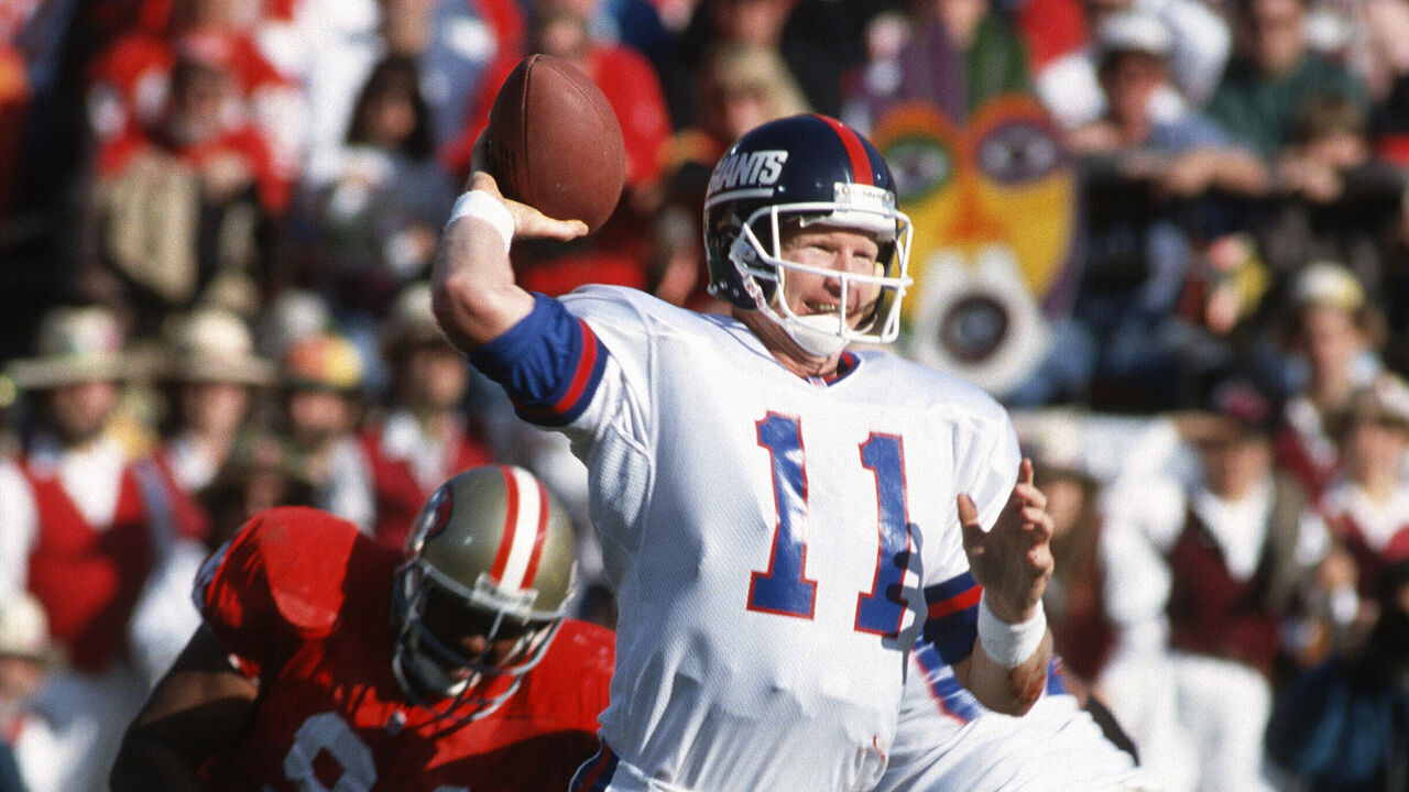 SAN FRANCISCO, CA - JANUARY 15: Phil Simms #11 of the New York Giants drops back to pass against the San Francisco 49ers during the NFC Divisional Playoff Game January 15, 1994 at Candlestick Park in San Francisco California. Simms played for the Giants from 1979-93.
