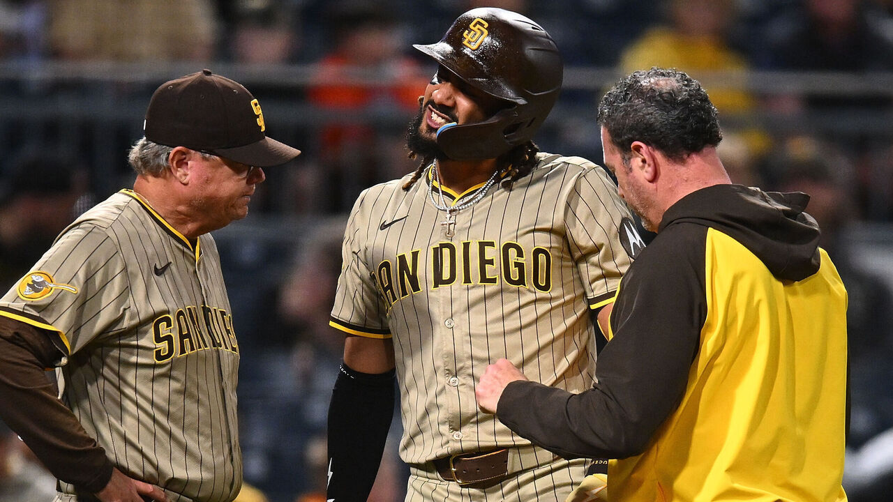 PITTSBURGH, PENNSYLVANIA - MAY 2: Fernando Tatis Jr. #23 of the San Diego Padres is looked at by training staff after being hit by a pitch during the third inning against the Pittsburgh Pirates at PNC Park on May 2, 2025 in Pittsburgh, Pennsylvania.