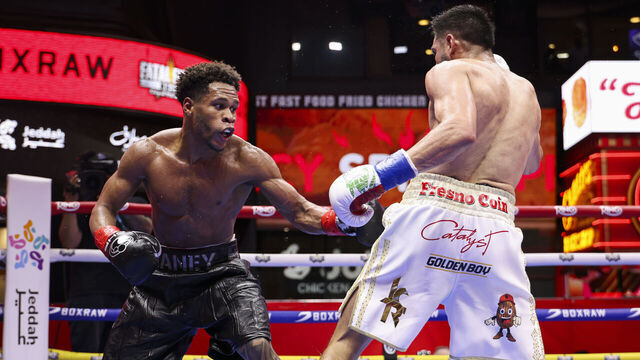 NEW YORK, NEW YORK - MAY 02: Devin Haney throws a punch at Jose Ramirez during a fight in Times Square on May 02, 2025 in New York City.
