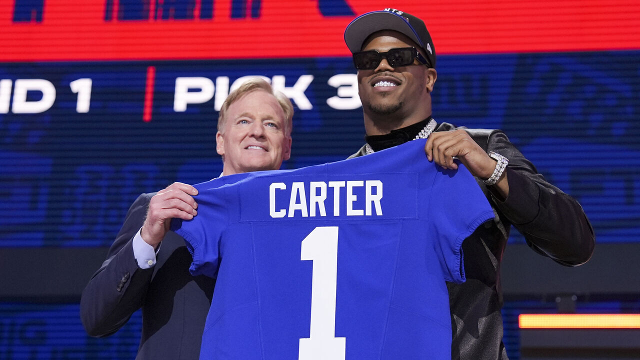 GREEN BAY, WISCONSIN - APRIL 24: Penn State defensive end Abdul Carter and Commissioner Roger Goodell pose after being selected third overall by the New York Giants during the first round of the 2025 NFL Draft on April 24, 2025 in Green Bay, Wisconsin.