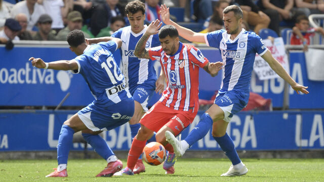 Atletico Madrid's Argentine forward #10 Angel Correa (C) fights for the ball with Alaves' Uruguayan defender #12 Santiago Mourino and Alaves' Spanish midfielder #24 Joan Jordan Moreno during the Spanish league football match between Deportivo Alaves and Club Atletico de Madrid at the Mendizorroza stadium in Vitoria on May 3, 2025.