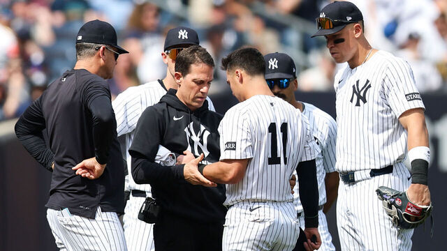 NEW YORK, NEW YORK - MAY 03: Anthony Volpe #11 of the New York Yankees has his arm inspected after a play during the eighth inning of the game against the Tampa Bay Rays at Yankee Stadium on May 03, 2025 in New York City.