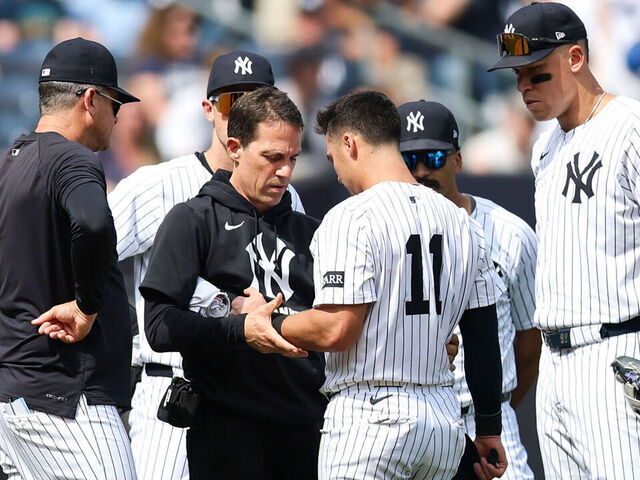 NEW YORK, NEW YORK - MAY 03: Anthony Volpe #11 of the New York Yankees has his arm inspected after a play during the eighth inning of the game against the Tampa Bay Rays at Yankee Stadium on May 03, 2025 in New York City.