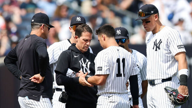 NEW YORK, NEW YORK - MAY 03: Anthony Volpe #11 of the New York Yankees has his arm inspected after a play during the eighth inning of the game against the Tampa Bay Rays at Yankee Stadium on May 03, 2025 in New York City.