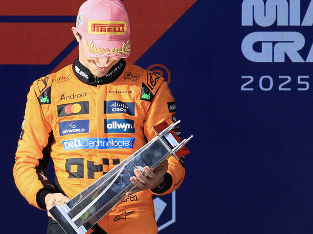 McLaren's Australian driver Oscar Piastri looks at his trophy after winning the 2025 Miami Formula One Grand Prix at Miami International Autodrome in Miami Gardens, Florida, on May 4, 2025.