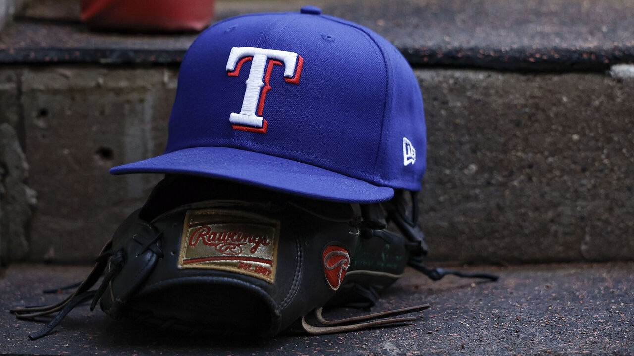 CINCINNATI, OHIO - MARCH 31: A detail of the Texas Rangers logo on a hat in the dugout prior to a game against the Cincinnati Reds at Great American Ball Park on March 31, 2025 in Cincinnati, Ohio.