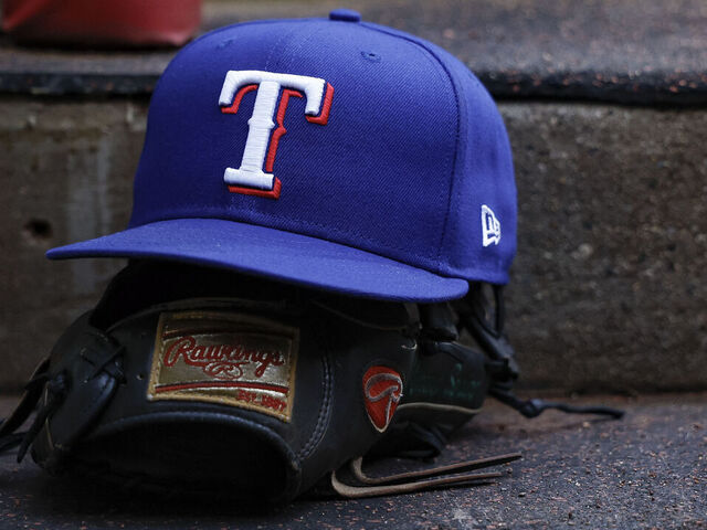 CINCINNATI, OHIO - MARCH 31: A detail of the Texas Rangers logo on a hat in the dugout prior to a game against the Cincinnati Reds at Great American Ball Park on March 31, 2025 in Cincinnati, Ohio.