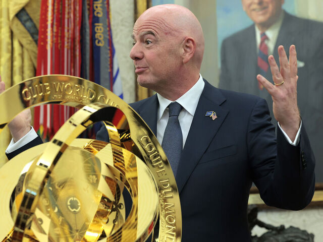 WASHINGTON, DC - MARCH 07: President of Fédération Internationale de Football Association (FIFA) Gianni Infantino (R) unveils the Club World Cup trophy alongside U.S. President Donald Trump in the Oval Office at the White House on March 07, 2025 in Washington, DC. President Trump signed an executive order establishing a White House Task Force for the 2026 World Cup.