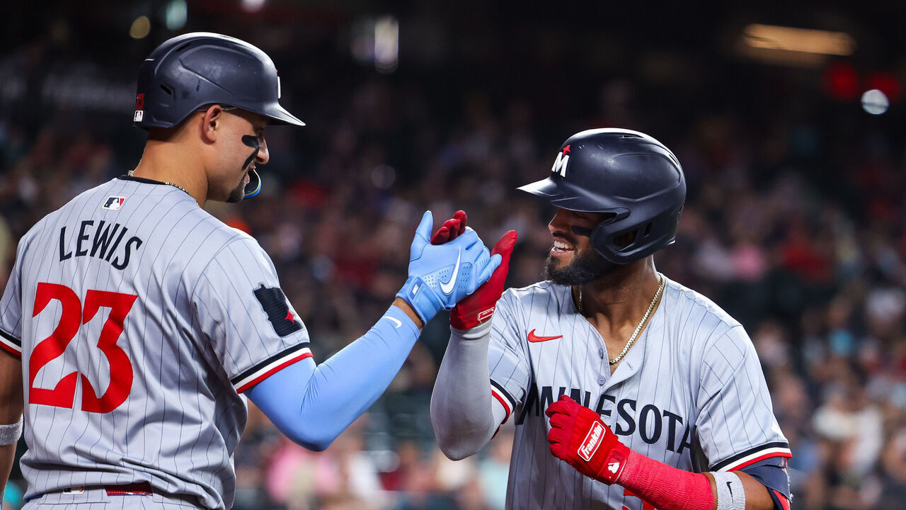 PHOENIX, ARIZONA - JUNE 26: Willi Castro #50 of the Minnesota Twins celebrates his two-run home run with Royce Lewis #23 in the fifth inning of a baseball game against the Arizona Diamondbacks at Chase Field on June 26, 2024 in Phoenix, Arizona.
