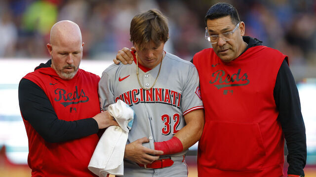 ATLANTA, GEORGIA - MAY 05: Tyler Callihan #32 of the Cincinnati Reds is helped off the field following a collision with the wall during the third inning against the Atlanta Braves at Truist Park on May 5, 2025 in Atlanta, Georgia.