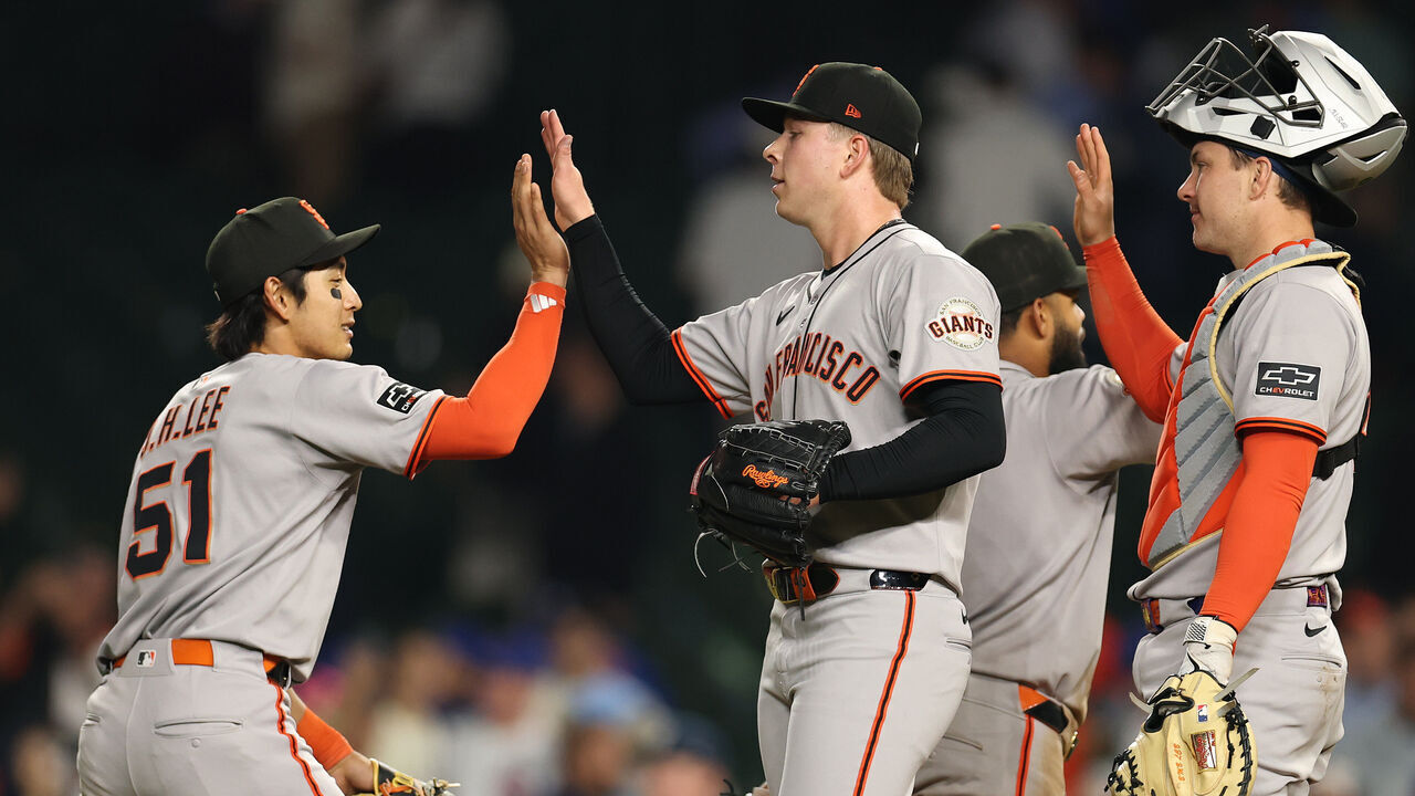 CHICAGO, ILLINOIS - MAY 06: Jung Hoo Lee #51 and Kyle Harrison #45 of the San Francisco Giants celebrate after defeating the Cubs 14-5 at Wrigley Field on May 06, 2025 in Chicago, Illinois.