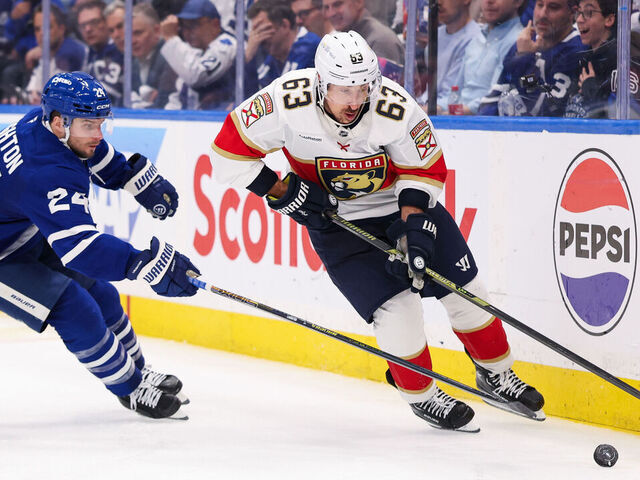 TORONTO, CANADA - MAY 5: Brad Marchand #63 of the Florida Panthers skates with the puck against Scott Laughton #24 of the Toronto Maple Leafs during the second period of Game One of the Second Round of the 2025 Stanley Cup Playoffs at Scotiabank Arena on May 5, 2025 in Toronto, Ontario, Canada.