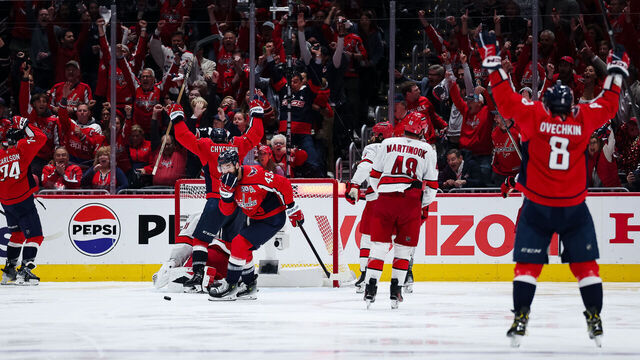 WASHINGTON, DC - MAY 08: Alex Ovechkin #8, Tom Wilson #43, and Jakob Chychrun #6 of the Washington Capitals celebrate after teammate John Carlson #74 scored a goal against Frederik Andersen #31 of the Carolina Hurricanes during the third period in Game Two of the Second Round of the 2025 Stanley Cup Playoffs at Capital One Arena on May 8, 2025 in Washington, DC.