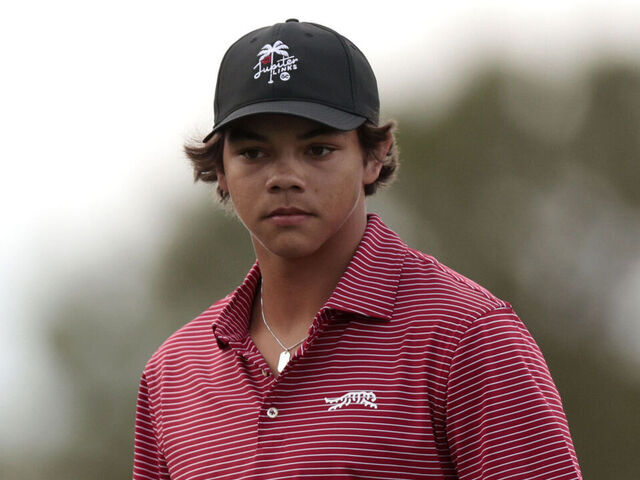 ORLANDO, FLORIDA - DECEMBER 22: Tiger Woods of the United States and his son Charlie Woods react on the 18th green during the second round of the PNC Championship at Ritz-Carlton Golf Club on December 22, 2024 in Orlando, Florida.