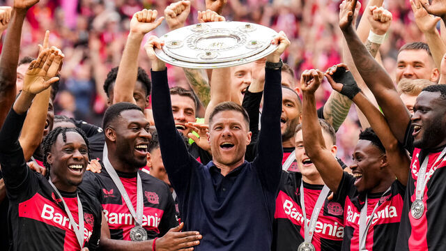 LEVERKUSEN, GERMANY - MAY 18: Bayer 04 Leverkusen head coach Xabi Alonso lifts up the Bundesliga Meisterschale trophy following winning the Bundeliga title after the Bundesliga match between Bayer 04 Leverkusen and FC Augsburg at BayArena on May 18, 2024 in Leverkusen, Germany.