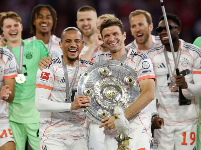 MUNICH, GERMANY - MAY 10: Thomas Mueller and Leroy Sane of Bayern Munich celebrate with the Meisterschale trophy after the teams 2-0 victory in the Bundesliga match between FC Bayern München and Borussia Mönchengladbach at Allianz Arena on May 10, 2025 in Munich, Germany.