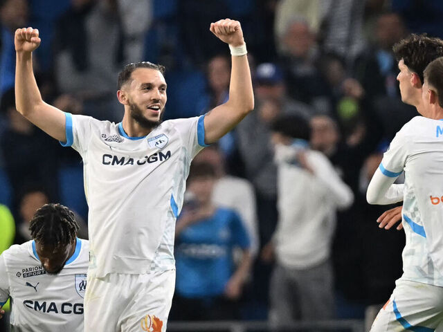TOPSHOT - Marseille's Algerian forward #09 Amine Gouiri (L) celebrates after scoring his team's third goal at the end of the French L1 football match between Le Havre AC and Olympique de Marseille (OM) at The Stade Oceane in Le Havre, north-western France, on May 10, 2025. Shortly after the hour mark and opening goal of Marseille, a brawl broke out in a corner adjacent to the Le Havre kop and spectators left the stand to take cover, bringing the match to a halt in the 64th minute and prompting referee Willy Delajod to send the players back to the dressing room.