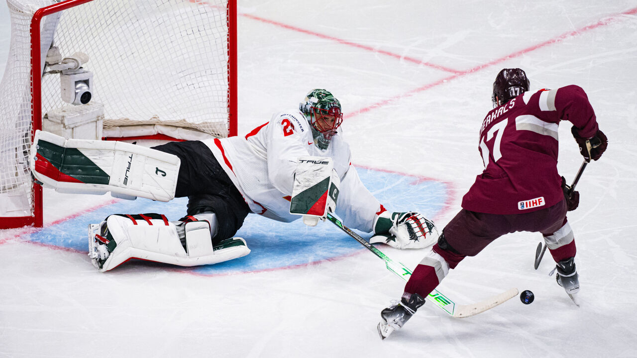 Canada's goaltender #29 Marc Andre Fleury reaches out to block the puck from Latvia's forward #17 Martins Dzierkals during the IIHF Men's Ice hockey World Championship match between Latvia and Canada in Stockholm, on May 11, 2025.