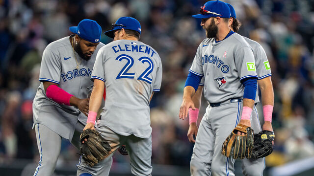 SEATTLE, WA - MAY 11: Vladimir Guerrero Jr. #27 of the Toronto Blue Jays, left, Ernie Clement #22, and Nathan Lukes #38 of the Toronto Blue Jays celebrate after a game against the Seattle Mariners at T-Mobile Park on May 11, 2025 in Seattle, Washington. The Blue Jays won 9-1.