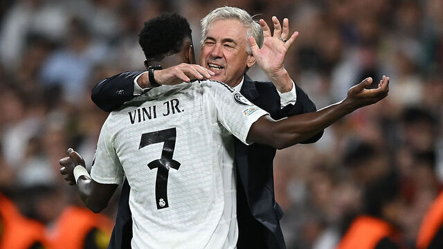 MADRID, SPAIN - OCTOBER 22: Vinicius Junior of Real Madrid celebrates with Carlo Ancelotti, Head Coach of Real Madrid, after scoring his team's fifth goal during the UEFA Champions League 2024/25 League Phase MD3 match between Real Madrid C.F. and Borussia Dortmund at Estadio Santiago Bernabeu on October 22, 2024 in Madrid, Spain.