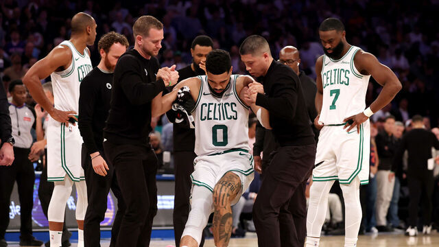 NEW YORK, NEW YORK - MAY 12: Jayson Tatum #0 of the Boston Celtics is assisted off court after being injured against the New York Knicks during the fourth quarter in Game Four of the Eastern Conference Second Round NBA Playoffs at Madison Square Garden on May 12, 2025 in New York City.