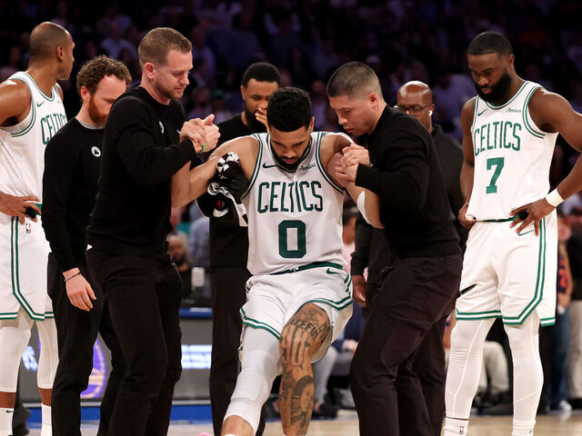 NEW YORK, NEW YORK - MAY 12: Jayson Tatum #0 of the Boston Celtics is assisted off court after being injured against the New York Knicks during the fourth quarter in Game Four of the Eastern Conference Second Round NBA Playoffs at Madison Square Garden on May 12, 2025 in New York City.