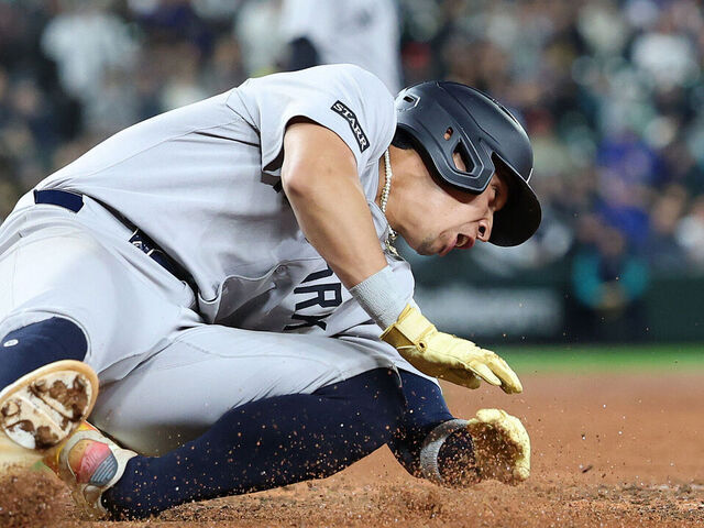 SEATTLE, WASHINGTON - MAY 12: Oswaldo Cabrera #95 of the New York Yankees scores a run against the Seattle Mariners during the ninth inning but injures himself at T-Mobile Park on May 12, 2025 in Seattle, Washington.