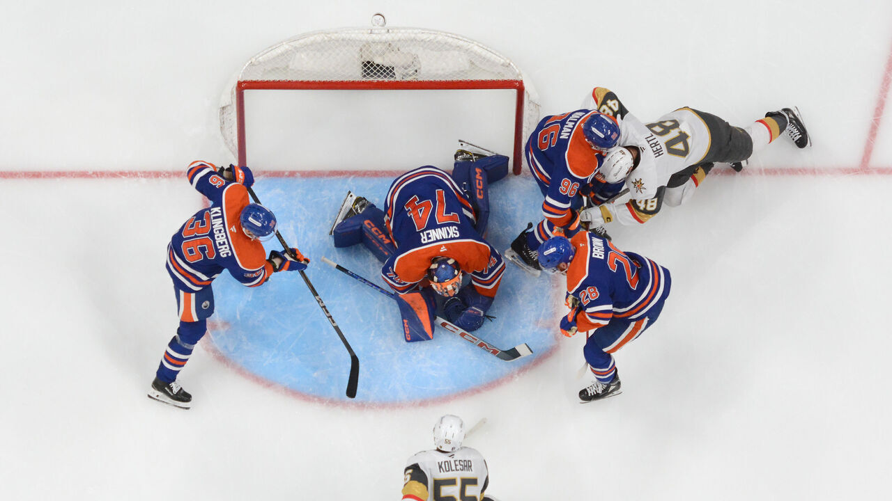 EDMONTON, CANADA - MAY 12: Stuart Skinner #74 of the Edmonton Oilers smothers the puck as players search for the rebound during the second period of Game Four of the Second Round of the Stanley Cup Playoffs against the Vegas Golden Knights at Rogers Place on May 12, 2025, in Edmonton, Alberta, Canada.