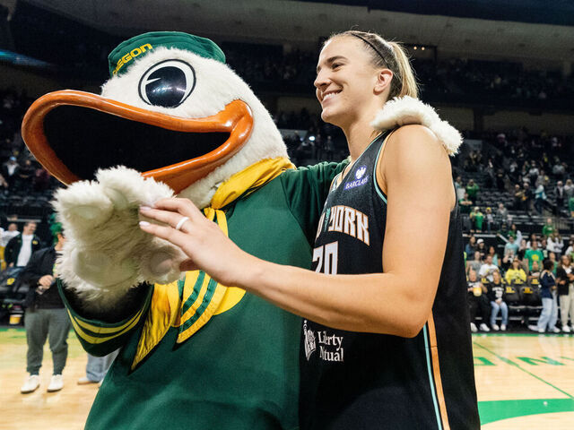 EUGENE, OREGON - MAY 12: Sabrina Ionescu #20 of the New York Liberty poses the Oregon Duck mascot after the Liberty preseason win over the Toyota Antelopes at Matthew Knight Arena on May 12, 2025 in Eugene, Oregon.