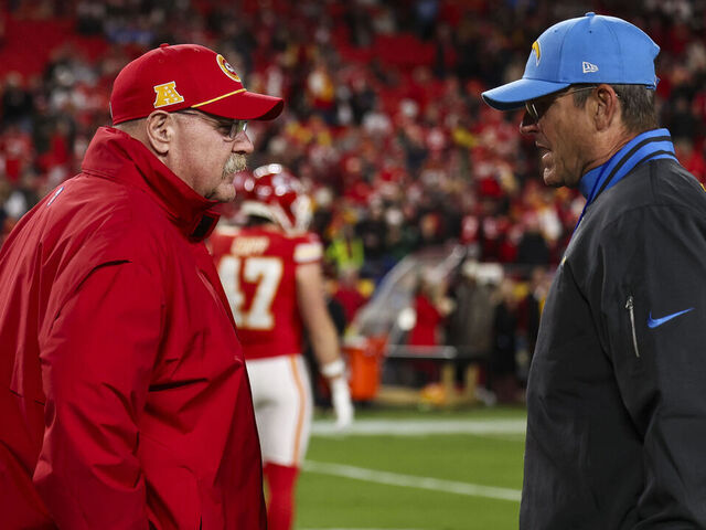 KANSAS CITY, MISSOURI - DECEMBER 08: Andy Reid of the Kansas City Chiefs talks with Jim Harbaugh of the Los Angeles Chargers prior to an NFL football game at GEHA Field at Arrowhead Stadium on December 8, 2024 in Kansas City, Missouri.