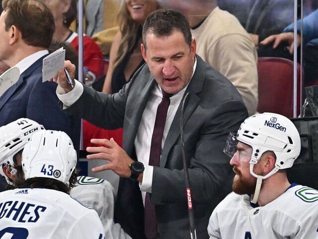 MONTREAL, CANADA - NOVEMBER 12: Adam Foote, assistant coach of the Vancouver Canucks, handles bench duties during the second period against the Montreal Canadiens at the Bell Centre on November 12, 2023 in Montreal, Quebec, Canada. The Vancouver Canucks defeated the Montreal Canadiens 5-2.