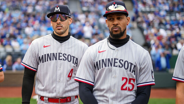 KANSAS CITY, MO - MARCH 30: Carlos Correa #4 looks on with Byron Buxton #25 against the Kansas City Royals on March 30, 2023 at Kauffman Stadium in Kansas City, Missouri.