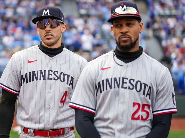 KANSAS CITY, MO - MARCH 30: Carlos Correa #4 looks on with Byron Buxton #25 against the Kansas City Royals on March 30, 2023 at Kauffman Stadium in Kansas City, Missouri.