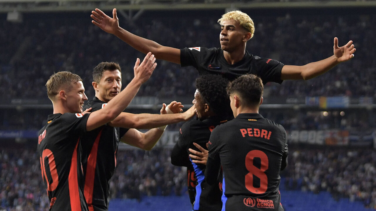 Barcelona's Spanish forward #19 Lamine Yamal (C) celebrates scoring his team's first goal during the Spanish league football match between RCD Espanyol and FC Barcelona at the RCDE Stadium in Cornella de Llobregat, on May 15, 2025.