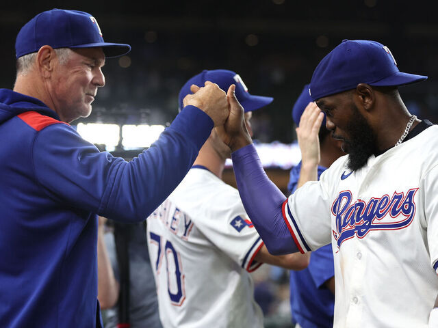 ARLINGTON, TEXAS - MAY 14: Manager Bruce Bochy #15 of the Texas Rangers and Adolis García #53 celebrate after defeating the Colorado Rockies at Globe Life Field on May 14, 2025 in Arlington, Texas.