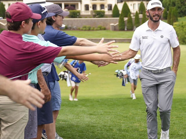 lang="x-default" CHARLOTTE, NC - MAY 16: Max Homa high fives spectators on his way to the eighth hole tee box during the second round of the PGA Championship at Quail Hollow Club on Friday, May 16, 2025 in Charlotte, North Carolina.