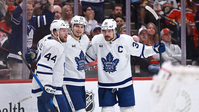 SUNRISE, FLORIDA - MAY 16: Auston Matthews #34 of the Toronto Maple Leafs, right, celebrates a goal against the Florida Panthers with teammates Morgan Rielly #44 and Matthew Knies #23 of the Toronto Maple Leafs during the third period in Game Six of the Second Round of the 2025 Stanley Cup Playoffs at Amerant Bank Arena on May 16, 2025 in Sunrise, Florida.