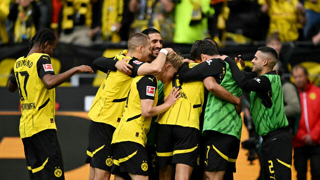 Dortmund's players celebrate after Dortmund's German midfielder #08 Felix Nmecha (4R) scored his team's third goal during the German first division Bundesliga football match between Borussia Dortmund and Holstein Kiel in Dortmund, western Germany, on May 17, 2025.