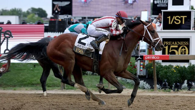 BALTIMORE, MARYLAND - MAY 17: Jockey Umberto Rispoli crosses the finish line on Journalism #2 to win the 150th Preakness Stakes at Pimlico Race Course on May 17, 2025 in Baltimore, Maryland.