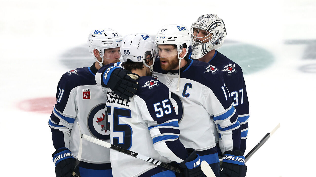 DALLAS, TEXAS - MAY 17: Mark Scheifele #55 and Adam Lowry #17 of the Winnipeg Jets hug after being defeated by the Dallas Stars in overtime to lose Game Six of the Second Round of the 2025 Stanley Cup Playoffs at American Airlines Center on May 17, 2025 in Dallas, Texas.