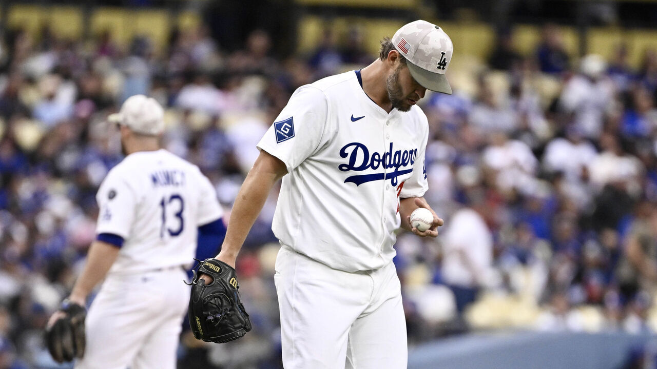 Los Angeles, CA - May 17: Starting pitcher Clayton Kershaw #22 of the Los Angeles Dodgers looks at the baseball after two runs score in the first inning during a baseball game against the Los Angeles Angels at Dodger Stadium in Los Angeles on Saturday, May 17, 2025.