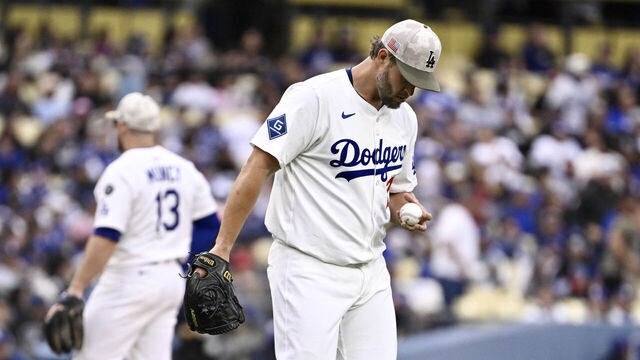 Los Angeles, CA - May 17: Starting pitcher Clayton Kershaw #22 of the Los Angeles Dodgers looks at the baseball after two runs score in the first inning during a baseball game against the Los Angeles Angels at Dodger Stadium in Los Angeles on Saturday, May 17, 2025.