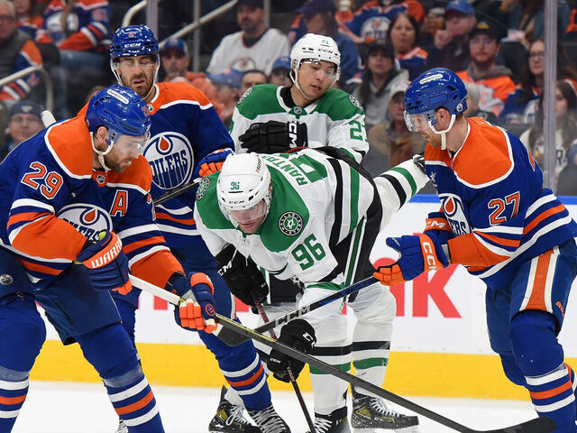 EDMONTON, CANADA - MARCH 08: Evan Bouchard #2, Leon Draisaitl #29 and Brett Kulak #27 of the Edmonton Oilers battle for the puck against Mikko Rantanen #96 and Jason Robertson #21 of the Dallas Stars during the third period of the game at Rogers Place on March 8, 2025, in Edmonton, Alberta, Canada.