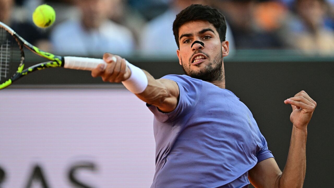 Spain's Carlos Alcaraz plays a forehand return to Italy's Jannik Sinner during their men's singles final match for the ATP Rome Open tennis tournament at Foro Italico in Rome on May 18, 2025.